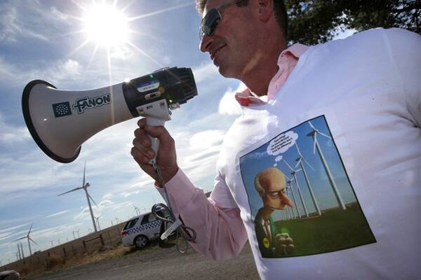 Tim Brew from Trawool  protests at the opening of the Macarthur wind farm this month. 