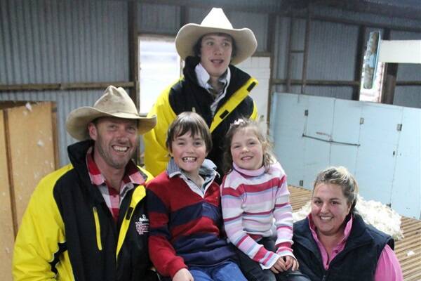Andrew, William, Kaylah and Angela Lyons with Jasper Bergner-Bowman in their woolshed at Vasey.