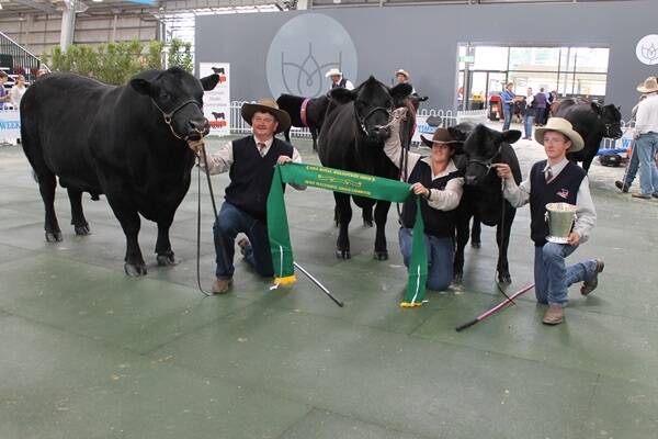 The Pine Creek Angus team, Bylong, NSW, with their grand champion bull and supreme exhibit cow and calf.