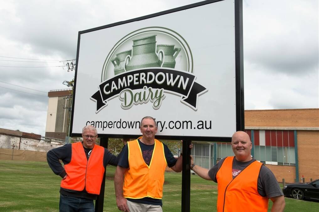 Camperdown Dairy quality and risk co-ordinator Gary Black (left), production co-ordinator Andrew Giles (centre) and site co-ordinator Paul Brown with the new signage at the Camperdown factory.