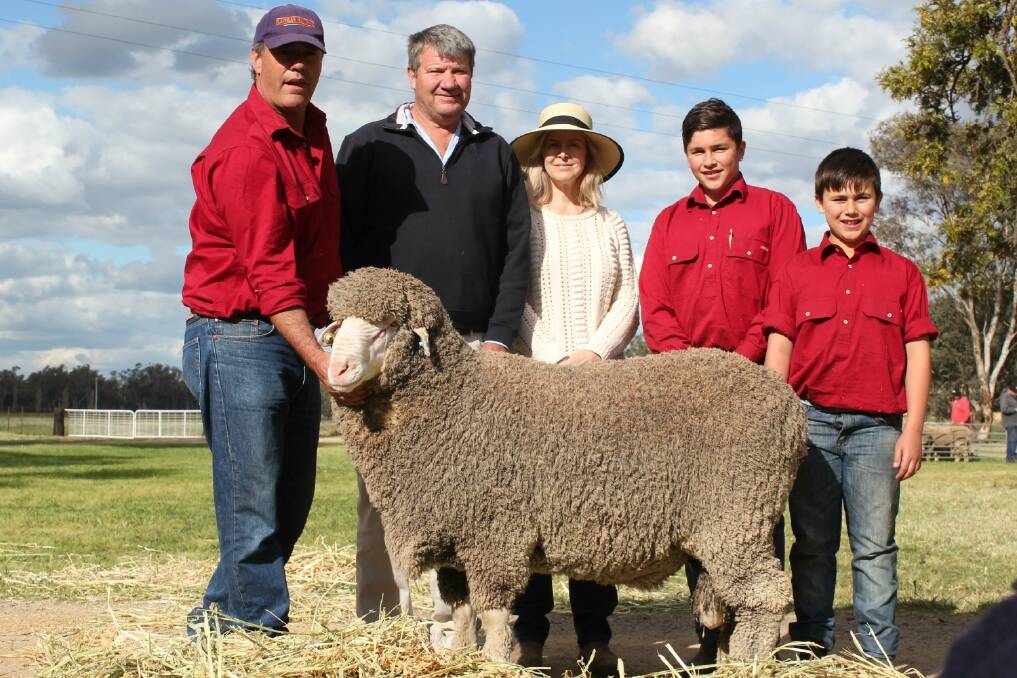 Glen Rubie of Lachlan Merinos, Forbes, NSW, with buyers of the top-priced $12,000 ram, Brett and Jenny Woods, Trundle, NSW. Pictured with Mitch and Cam Rubie.