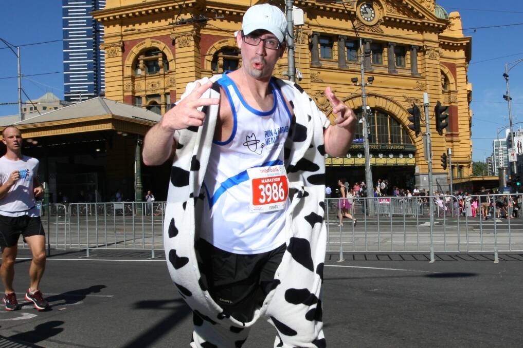 Edward Kus ran part of the Melbourne Marathon in a cow onesie
