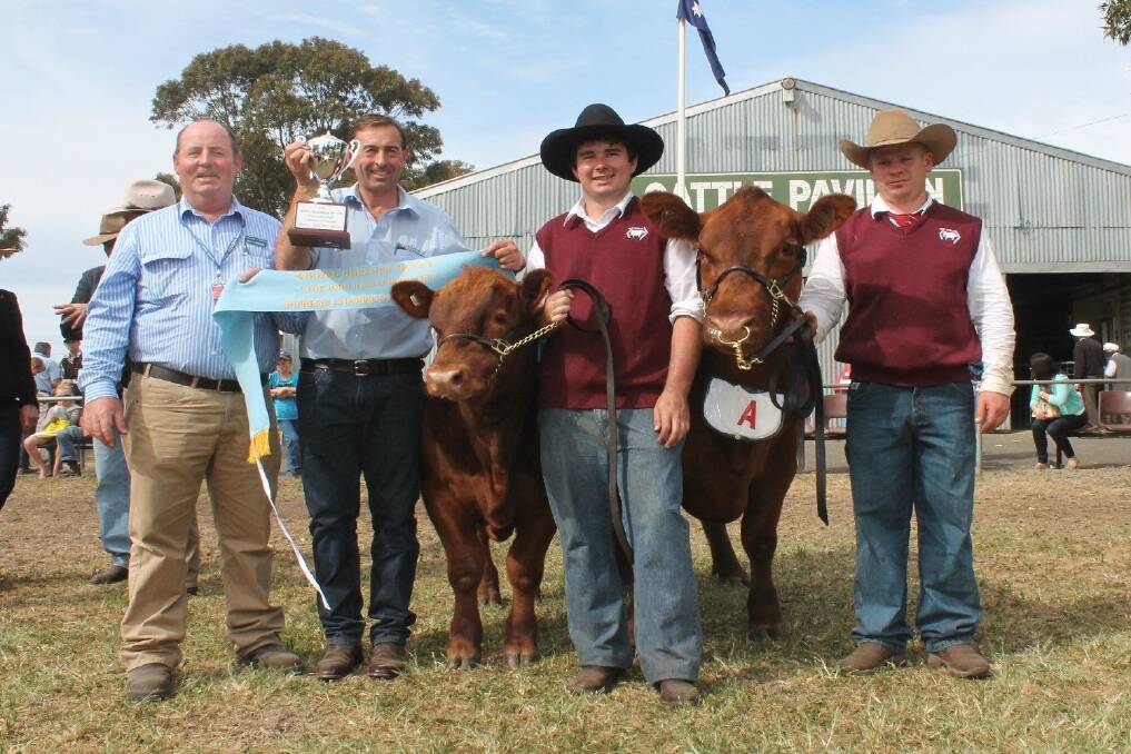 Royal Geelong Agricultural & Pastoral Society’s president Stuart Larcombe and Will Richardson, sponsor of the John Richardson Cup, named after his father, presented the supreme champion beef exhibit to BJ’s Essence G4 (led by Erin Grylls, far right), which had a seven-month-old bull calf at-foot (led by Hayden King).