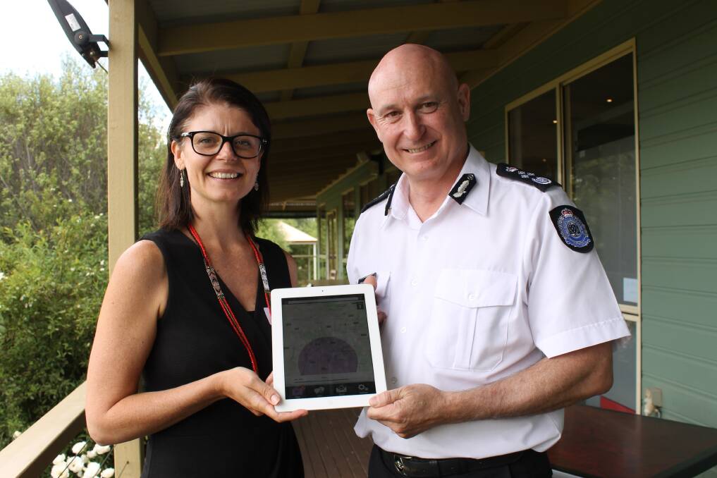 The Conexu Foundation's chief strategy officer Rachel McKay and Victoria's Emergency Management Commissioner Craig Lapsley show the OpenAccess Alerts app that the organisations worked together to develop to provide emergency warnings, including of bushfires, to Victorian who are deaf or hard of hearing.