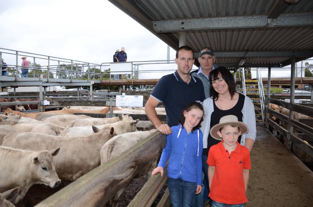 Vendors Heartsville Partnership, Tarrenlea, offered 100 Charolais/Angus crosses. Pictured are, back,   Ian Atchison, his son Glen, his wife Nichole and children Maddison and Joshua, both 7.