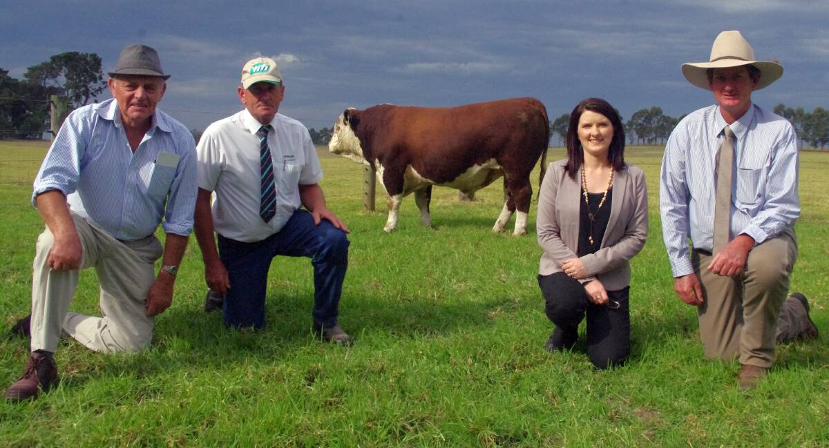 Peter Adams, Staghorn Flat (near Wodonga), East Gippsland Livestock's Geoff Nicholls and Mawarra principals Deanne and Peter Sykes, with the top priced poll Hereford bull from Monday's sale, lot 46, Media Baron. 
