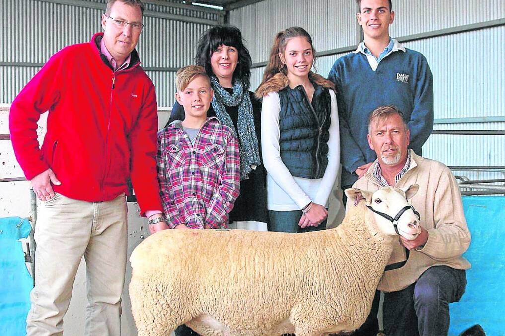 Pictured with the $3500 top-priced ewe at the Detpa Grove White Suffolk stud’s biannual mated-ewe sale were Elders auctioneer Ross Milne (left) with members of the Pipkorn family: Jordan, Michelle, Sophie, Alex and David (holding the ewe). It was bought by Bruce Buswell, Matilda Downs stud, Mount Barker, Western Australia, as one of 11 ewes Mr Buswell purchased.