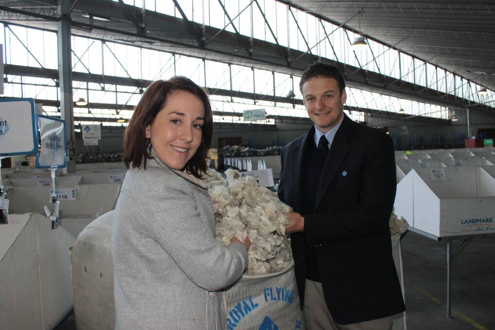 Royal Flying Doctor Service Victoria communications manager Lucy Sinclair and Australian Wool Network's Kelvin Shelley inspect one of the charity bales that was sold at Melbourne.
