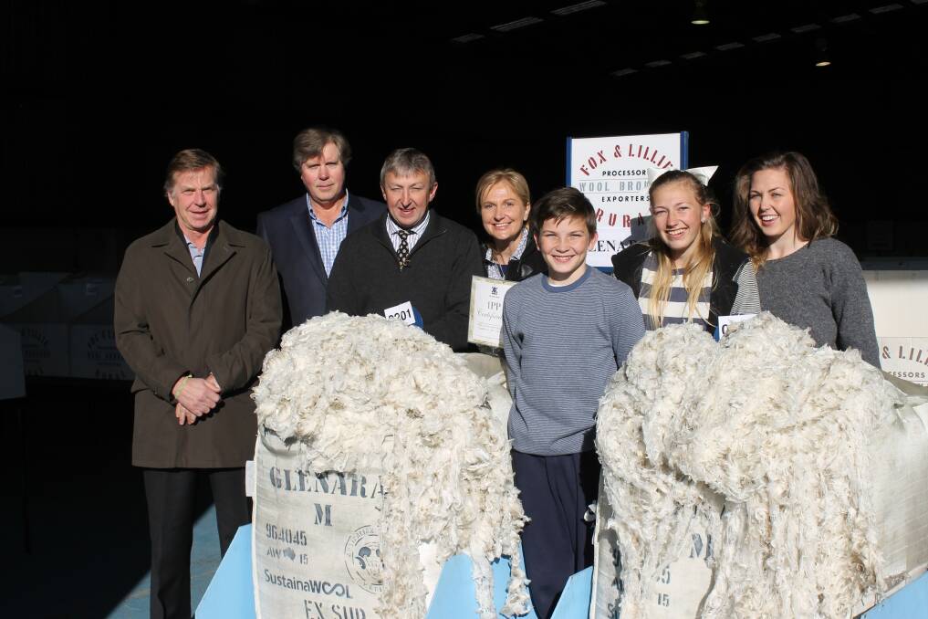 Fox & Lillie Rural co-owners James Lillie (left) and Jonathan Lillie with the Mibus family, Glenara Merino stud, Dunkeld, including Trevor, Kathy, Jacob, 14, Brooke, 15, and Rachael, 18, surround the 1PP bale.