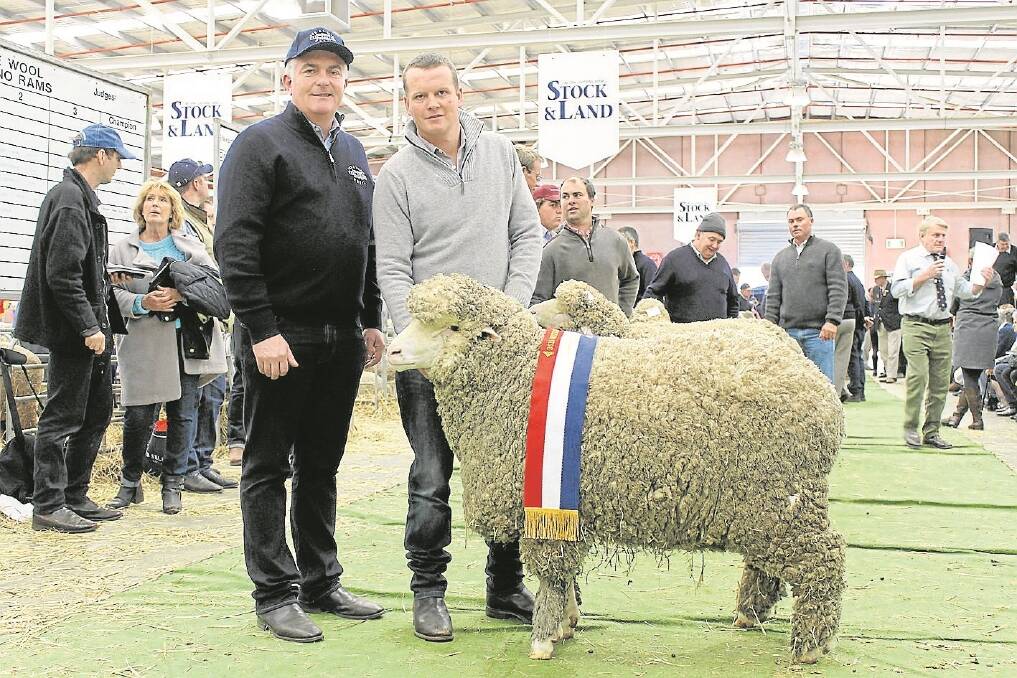 Eamon Timms, Fox and Lillie, and Poll Boonoke stud manager Angus Munro with the grand champion Poll Merino ram.