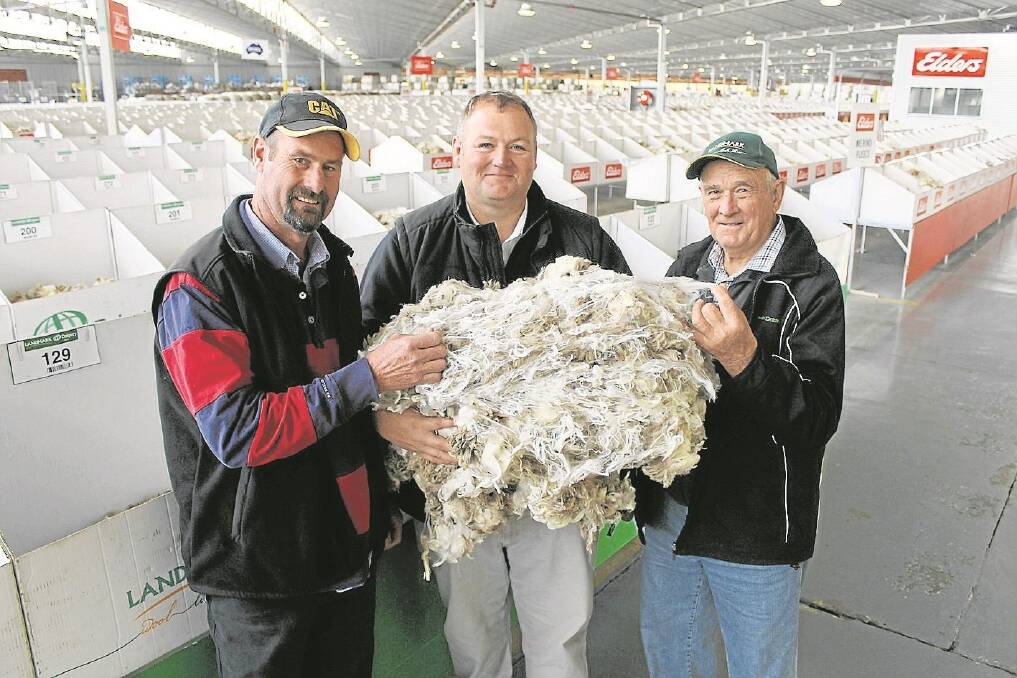 Wayne and Terry Scholz, Pleasant Hills, NSW, were pictured at the Melbourne wool stores with their agent David Johnson, Landmark.