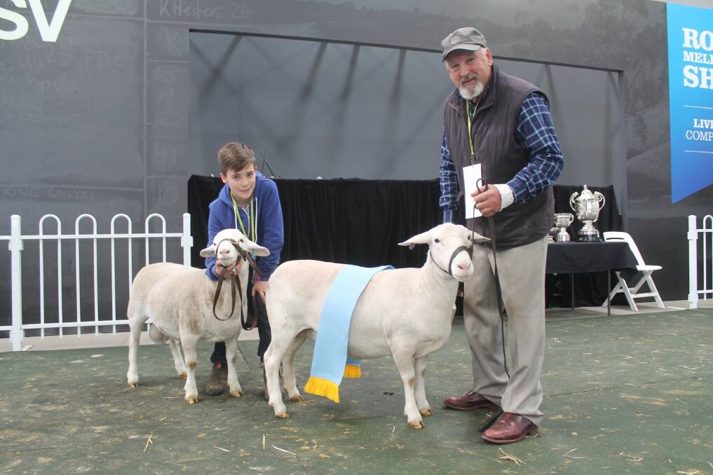 Graeme Collins, Merribrook, Milloo, holding the supreme champion White Dorper (a ewe), while Nick Voitin, 13, Drysdale, shows off the ewe's five-month-old ram lamb.