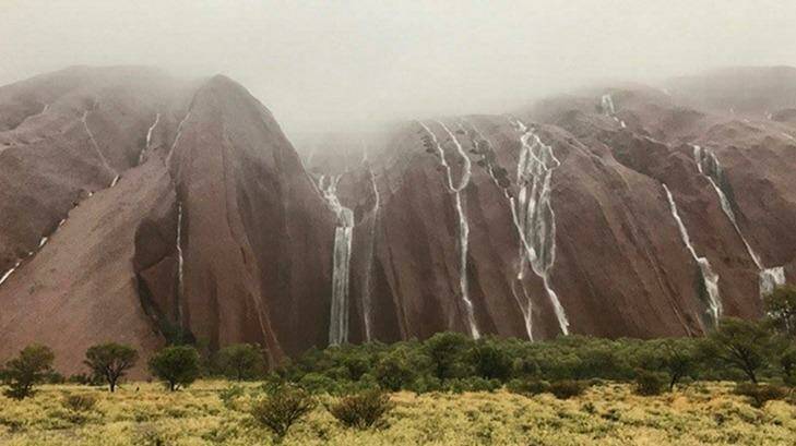 Record rainfall reached to the Red Centre during 2016, including the Christmas storms over Uluru. Photo: Parks Australia
