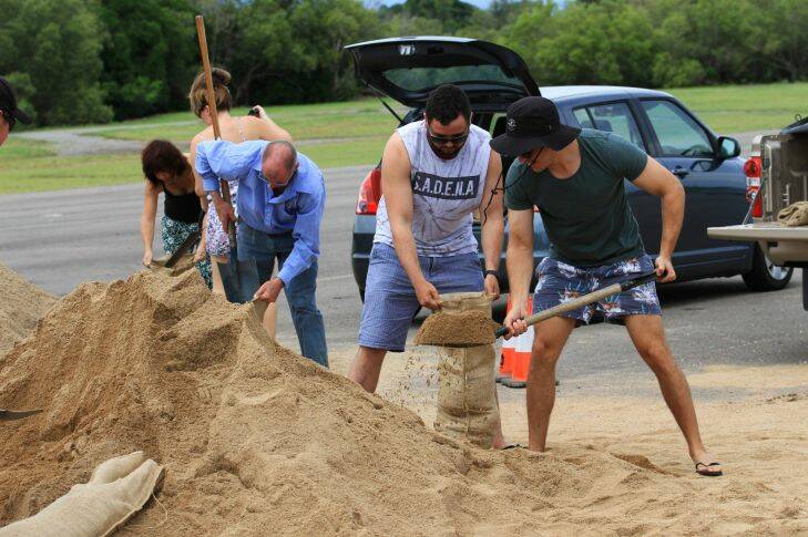 Huge piles of sand were dumped at Lou Lister Park for local residents to dig into with shovels and sandbags. Photo: Jorge Branco - Fairfax Media