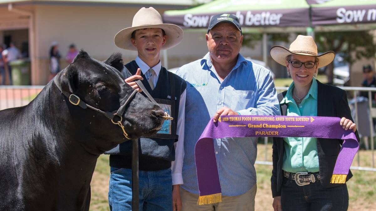 Lochie McLauchlan with Thomas Foods International representative Peter Bond and paraders judge Fiona McWilliam, Camden. Photo by Emily H Photography.