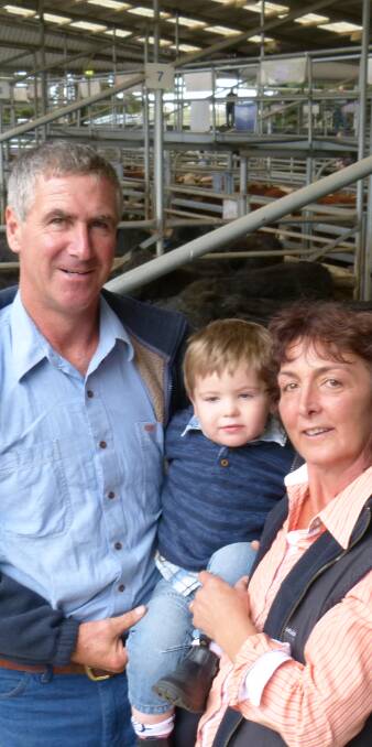 SELLING: Peter and Robyn Sandy, with grandson Beau French, sold 21 yearling Angus steers from $1180-$1330, or 292-295c/kg lwt, at Bairnsdale.