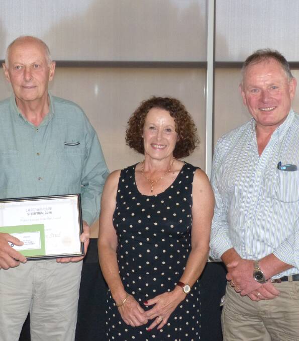 Bruce and Debbie Williams, Hollingrove Stud, Warragul, won first prize for carcase score (pair) for their two Speckle Park cross steers. John Schelling, Evans BP, presents.