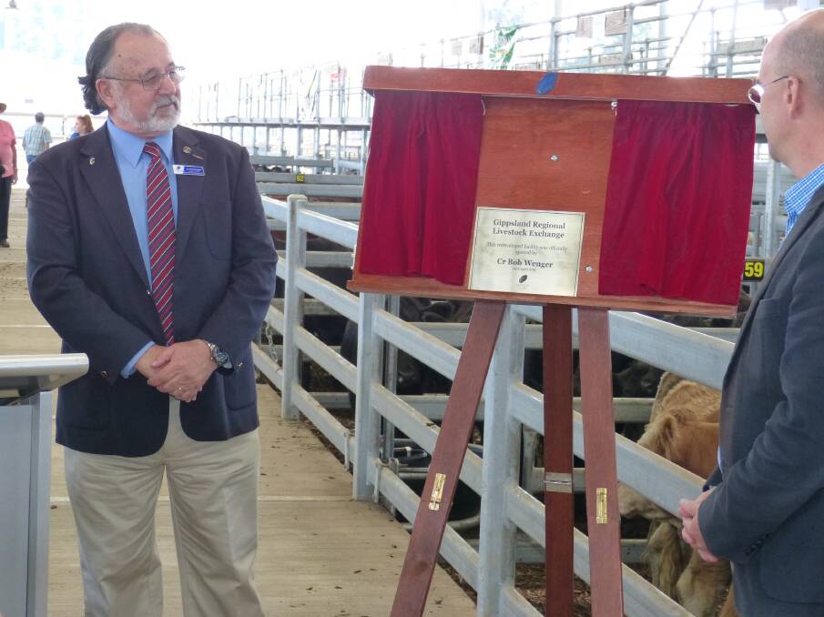 Wellington Shire Deputy Mayor, Cr Bob Wenger drew the cord to display the opening plaque of the GRLE saleyard with Member for Gippsland, Danny O'Brien, looking on.