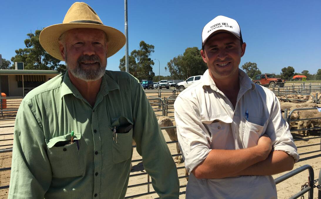 INSPECT: Pictured inspecting a pen of lambs at Corowa sale are Landmark's Roy Monte and Junee Abattoirs' Jules Gray. The lamb sale fell into line with other major selling centres, with prices easing $4-$10.