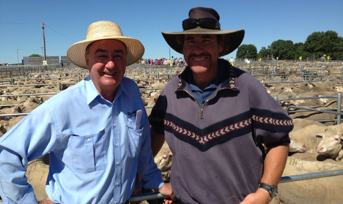 SOLD: Peter Dargan from Rodwells Wangaratta pictured with Trevor Bennett from "Hillview", Everton Upper, who sold Merino ewes to $86 at Corowa sale this week.