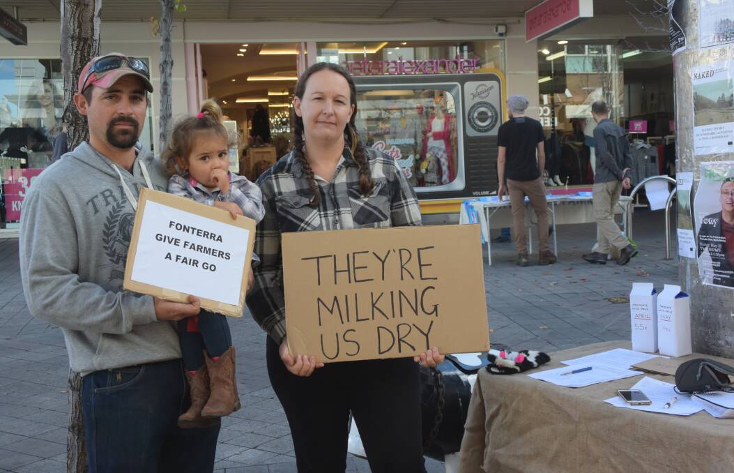 PRESSURE: Third-generation dairy farmer Byron Carins and his wife Danielle in the Launceston Mall protesting against the shock cuts to the milk price made by Murray Goulburn and Fonterra last week. Picture: Caitlin Jarvis.