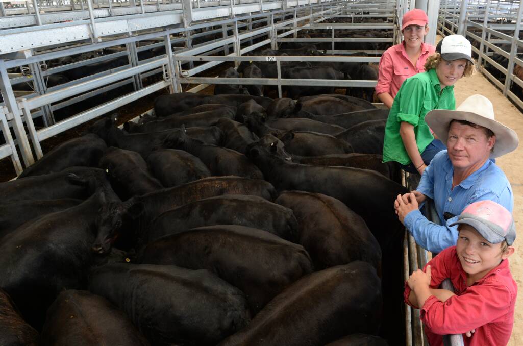 Simon Tooth, "Willow Park", Albury, with his children, Richie, 13, Georgie, 15, and Tom, 11, at the January weaner sales near Wodonga. 