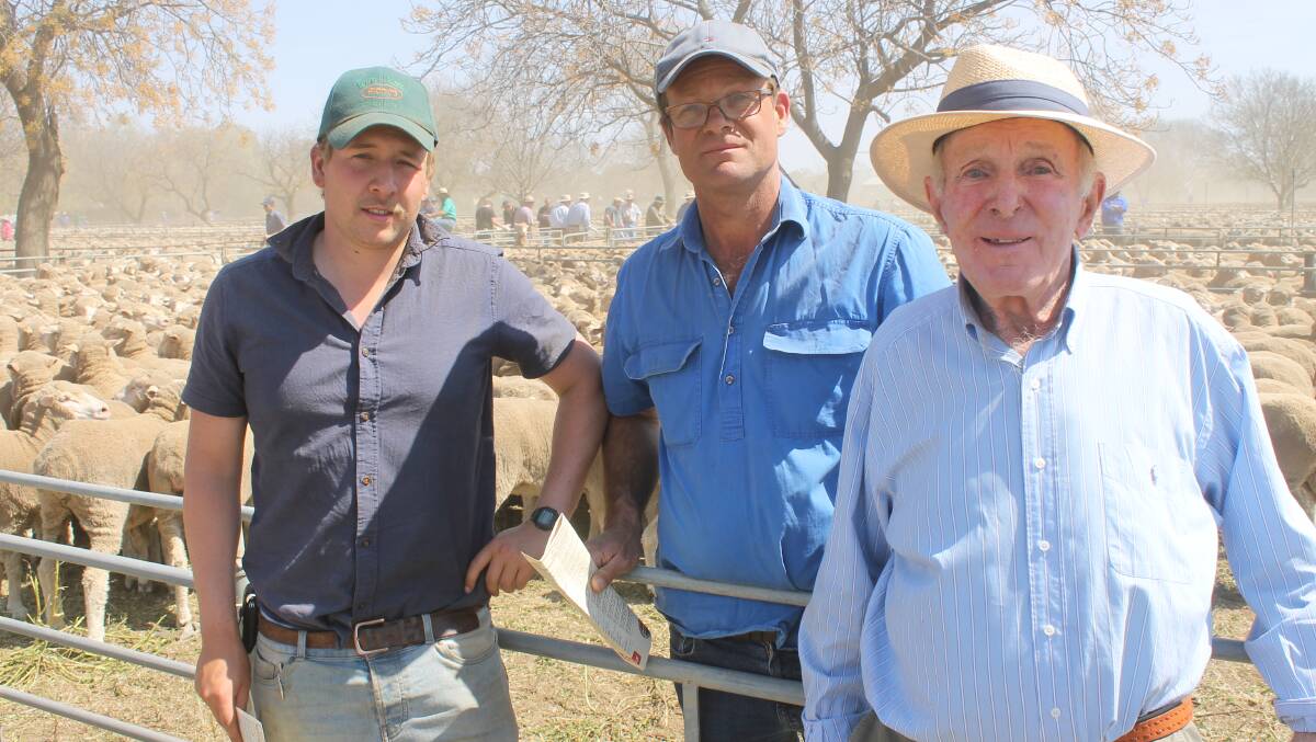 Nick and Neil McKindlay, Moulamein, with Tom Braithwaite (left) and their sale-topping $258/head ewes which priced $14 below last year.