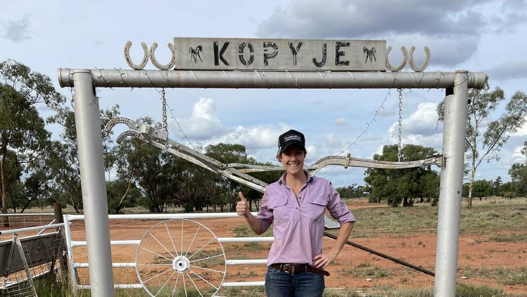 Stephanie Hughes at the front gate of Kopyje Station, which she bought mid-year for $5.2 million.