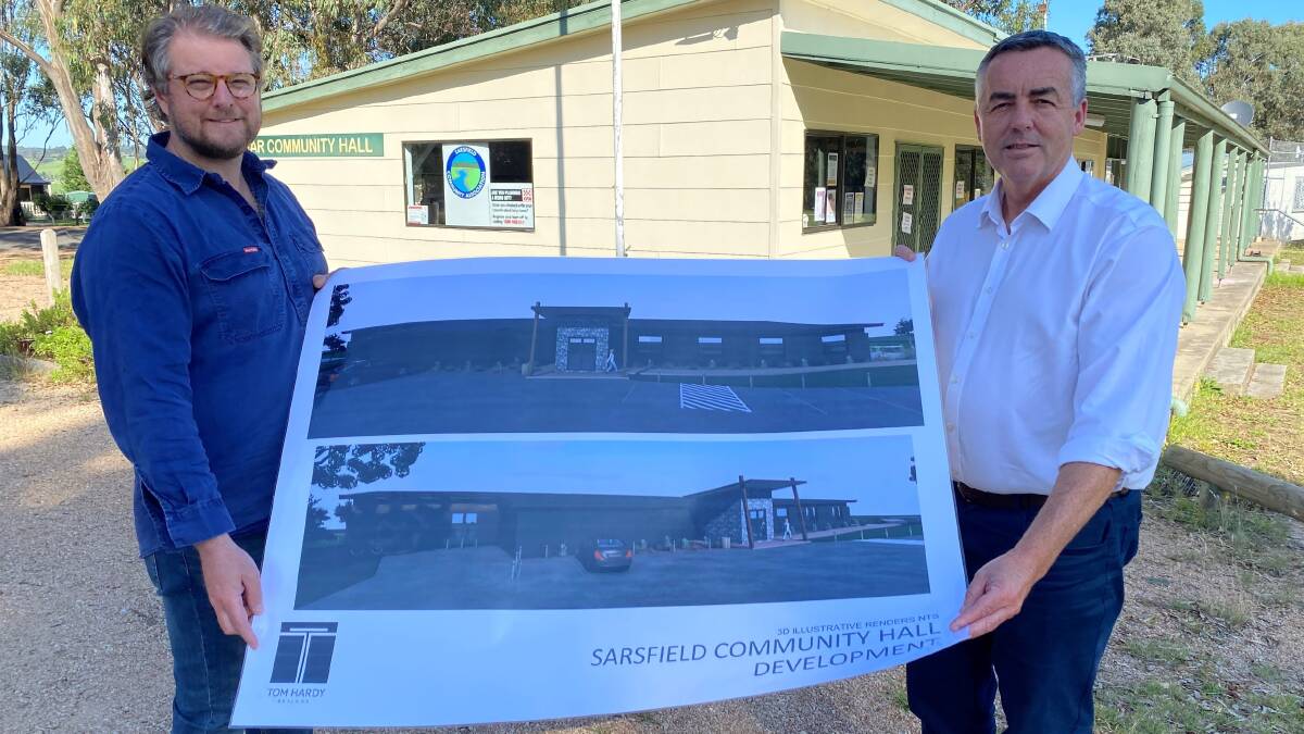 NEW PLANS: Sarsfield Community Association president Simon Hof and Member for Gippsland Darren Chester with Sarsfield Community Hall development plans after receiving new funding after initially being deemed ineligible over the committee's ABN status.