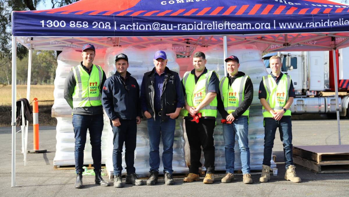 Members of the Rapid Relief Team assisting at a community event for flood-affected farmers at Yea earlier this month.