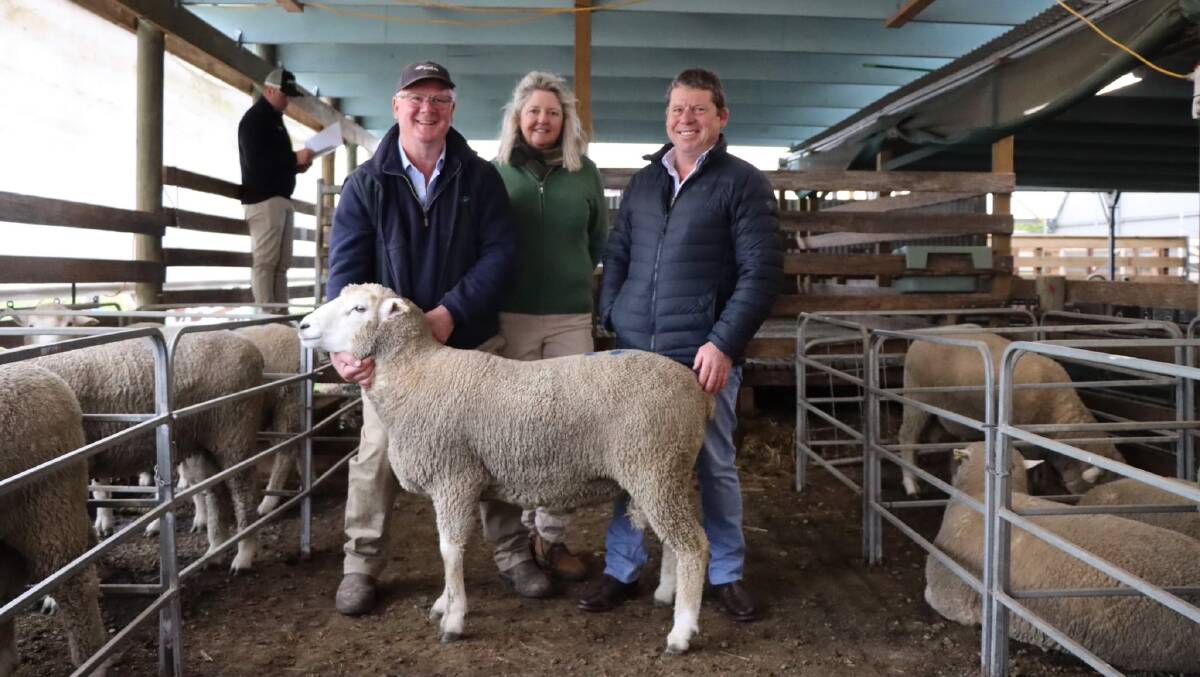 Blackwood stud principals Peter and Claire Blackwood, Evandale, Tasmania and buyer Philip Gough, Salamanca Pastoral, Hotspur with second top-priced ram, Lot 21 Blackwood 21-0140, used as a ram lamb and sold for $4000. Picture supplied.