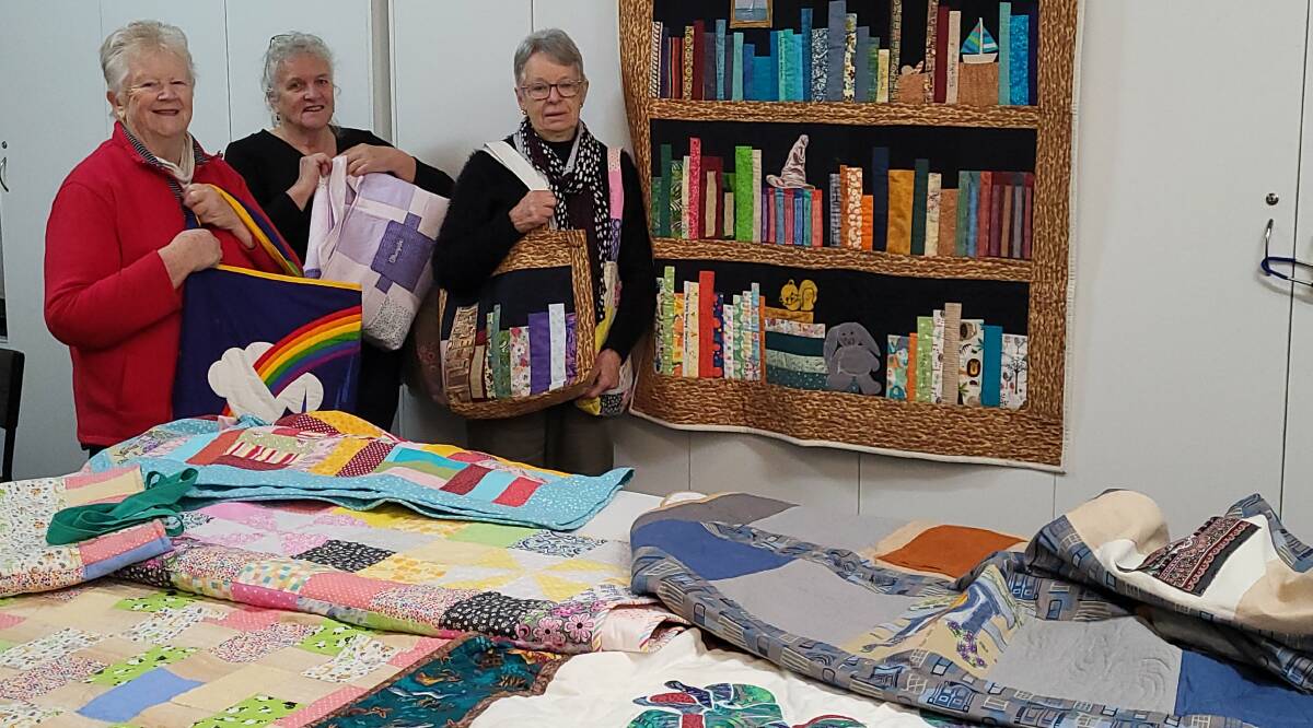 COMMUNITY: Kath Mahoney, Linda Junghenn and Annamarie Westendorp with quilts set to be donated to the Monash Children's Cancer Centre in Clayton.