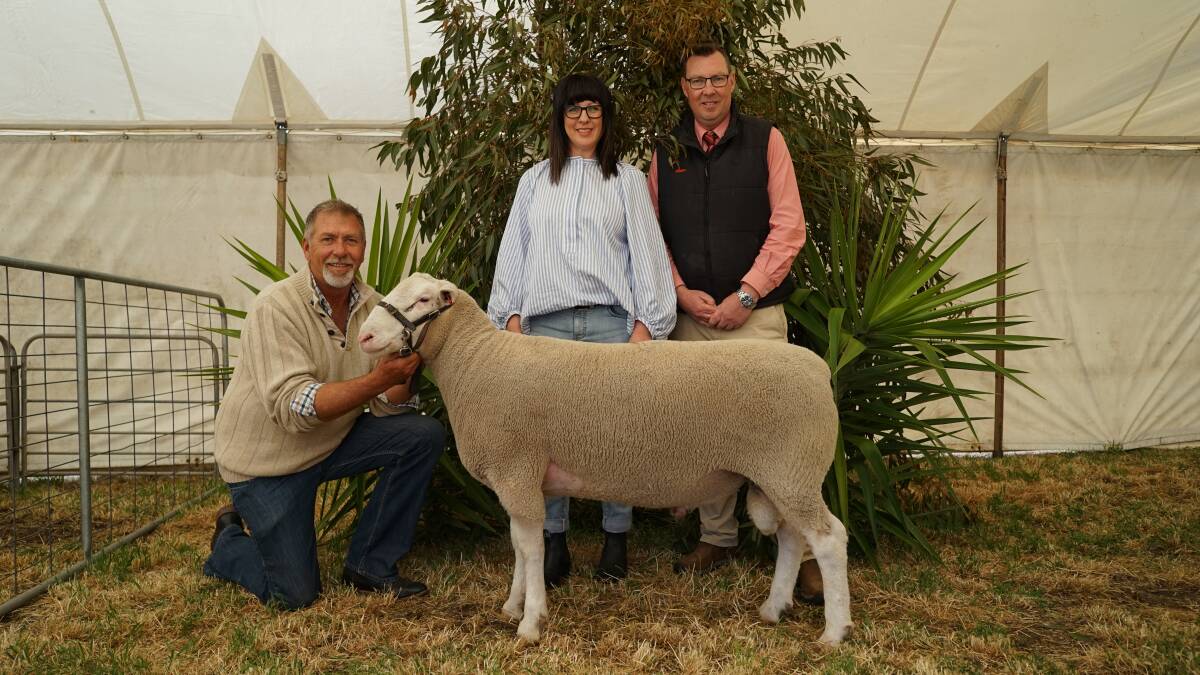 David and Michelle Pipkorn, Detpa Grove, Jeparit, and Elders auctioneer Ross Milne with Lot 79, 220128, at the stud's 35th annual sale. Picture by Rachel Simmonds