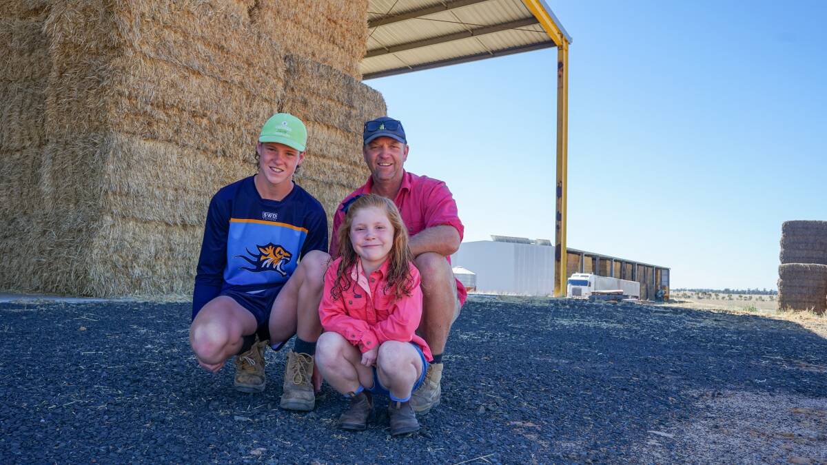 Nhill farmer Rob Bell with children Charlie, 13, and Rosie, 6, after a fantastic hay harvest. Picture by Rachel Simmonds