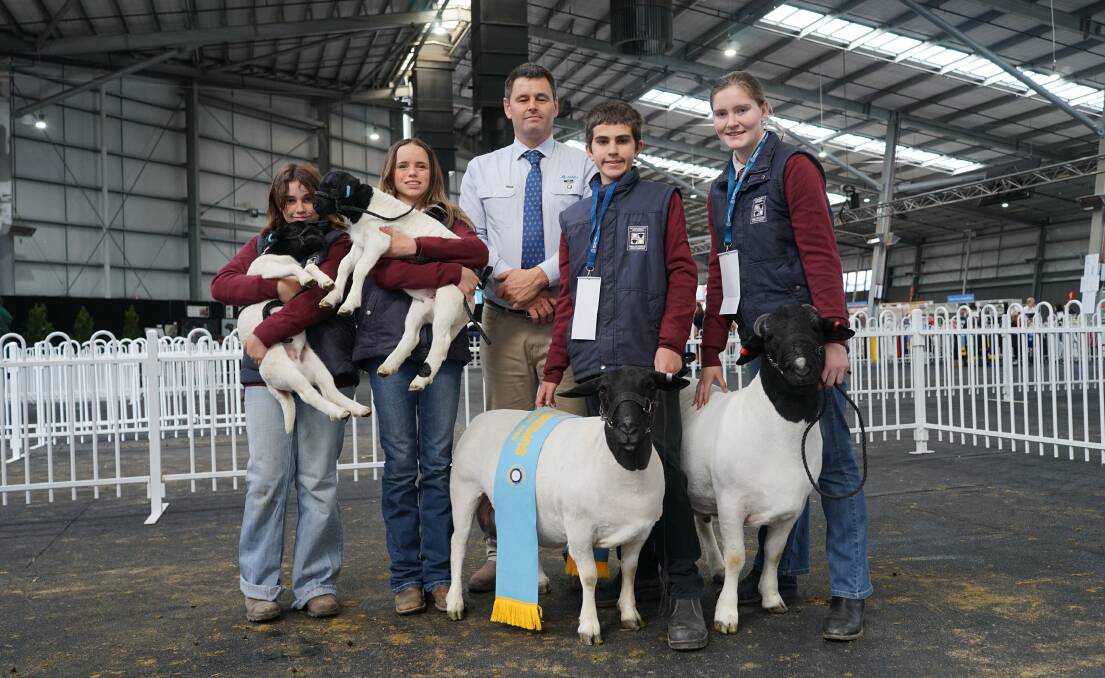 Hay War Memorial High School students Meredith Gaw and Evie Creighton, Dorper judge Nick Lawrence, students Robert Gaw and Kodi Scott, and the supreme Dorper champion and grand champion ram. Picture by Rachel Simmonds