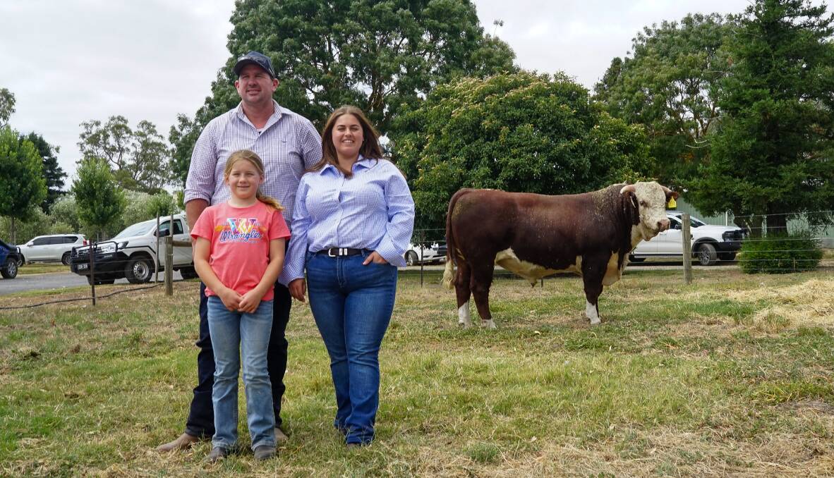 David and Milla McClure, 9, with Glendan Park stud co-principal Alicia Trovatello and the top-priced bull, Lot 2. Picture by Rachel Simmonds