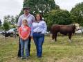 David and Milla McClure, 9, with Glendan Park stud co-principal Alicia Trovatello and the top-priced bull, Lot 2. Picture by Rachel Simmonds