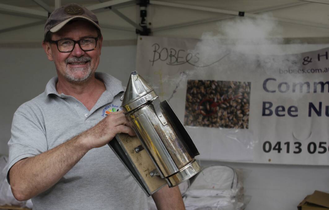 Andrew Stanish, Australian Bee Supplies, with a pine needle filled bee smoker. Picture by Holly McGuinness