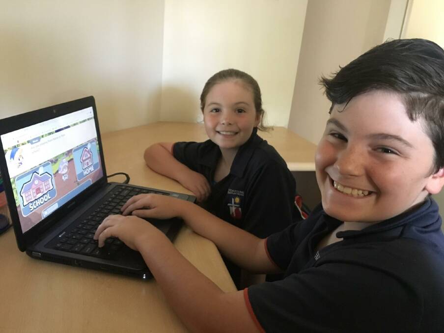 CONNECTED LEARNING: Students Grace and Henry Ball utilise a mobile connection to access an online tutorial site. 5G technology promises to increase access to remote learning, enabling virtual reality and 4K streaming. 