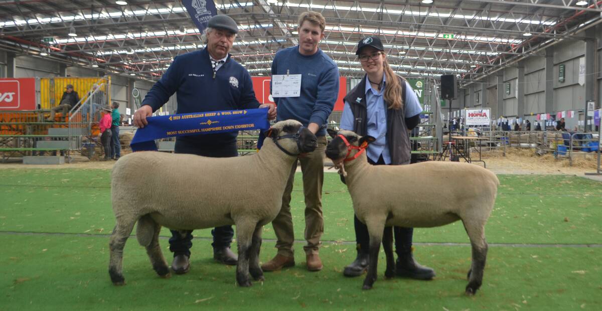 Judge Jeff Johnson, Eurack, presenting the sash for most successful exhibitor in the Hampshire Downs breed to Mathew Hill, Aurora Park, St Helens Plains, parading the supreme exhibit, the champion ram, while Emily Humphrey, Elisabeth Murdoch College, Langwarrin, parades the champion ewe also bred by Mr Hill. 
