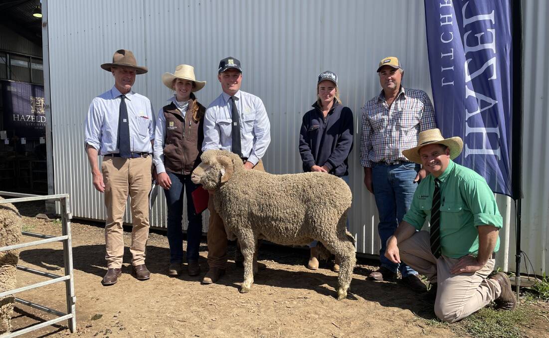 With the top priced ram: Jim Litchfield, Bea Litchfield, Ed Bradley, Hazeldean, Cooma with Ailee and Brett Tremain, Yeoval, and auctioneer Rick Power, Nutrien.