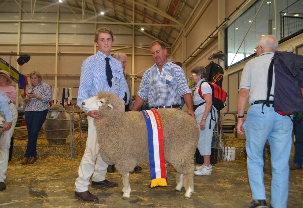 Dan Watkins, St Gregory's College, Campbelltown, and the champion Corriedale ewe, with judge, Milton Savage.