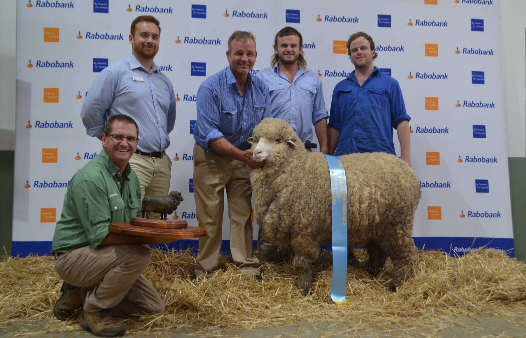 Landmark's Rick Power and Alex Hunt, Rabobank, Goulburn presenting the Kevin 'Dusty' Coves Memorial Trophy for supreme exhibit to Rod, Ned and George Evans, Tara Park, Boorowa, for their March-shorn medium/strong wool ewe.