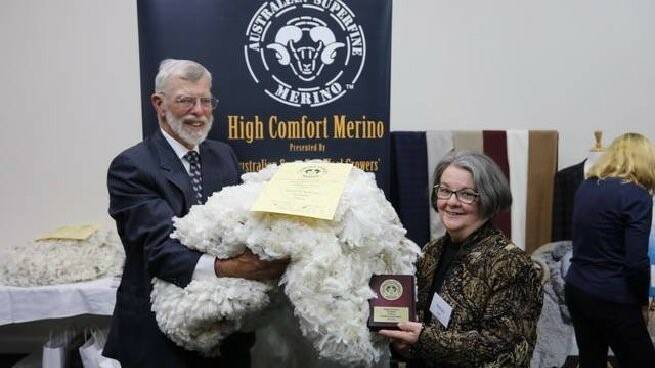 John and Robyn Ive with their winning fleece in the ASWGA Fleece competition in the Goulburn Yass Region. Photo: ASWGA