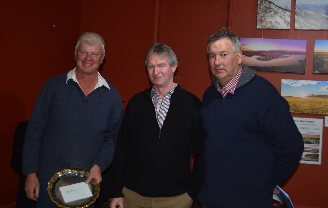 Neil Adams, "Wahroon", Cooma, winner of Mildon Trophy for first hoggets with his Cottage Park-blood sheep, with judges, Patrick Davis and Richard Chalker. 
