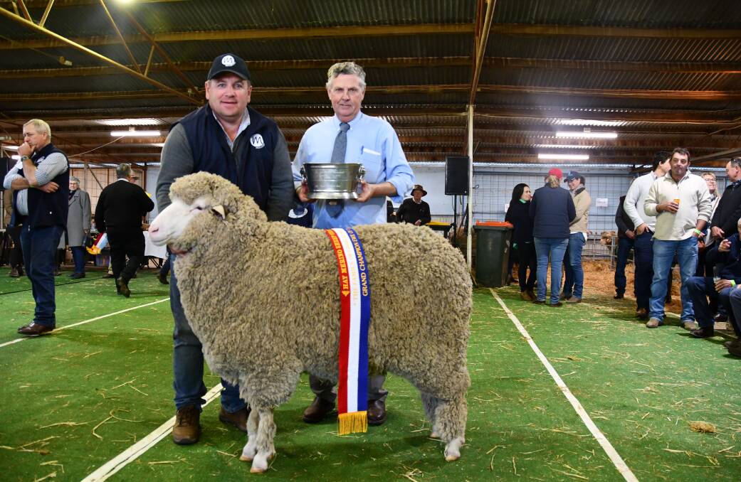 Paul Meyer, Mulloorie, Brinkworth, SA and Chris Bowman, Hay, presenting the trophy for grand champion ewe.