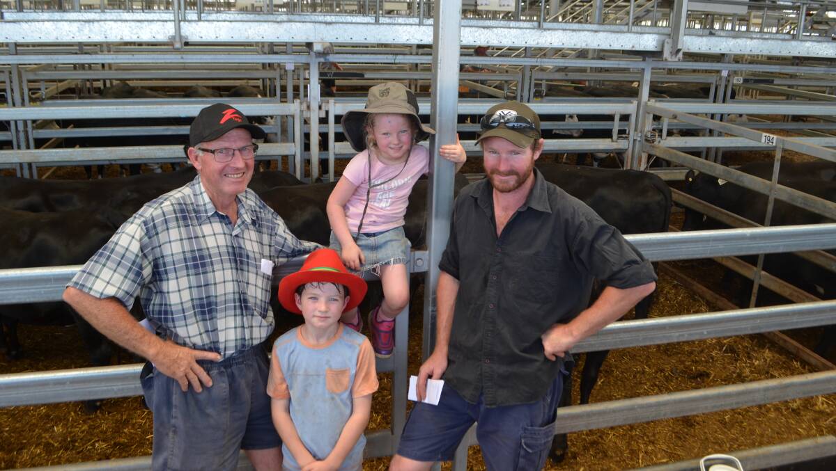 Neville Watkins, Charlock Partnership, Charleroi, Victoria with his grandchildren Darcy and Lauren and son Adrian offered 97 Angus and Hereford/Angus females to top at $1870.
