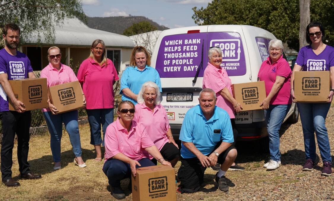 Good works: Foodbank drought hampers being distributed in North West NSW by Quirindi district volunteers Jenny Barker, Michele Robertson, Sandra Coles, Colleen Calder, Anne Ward and (front) Tammie Calder, Deborah Shiel and George Calder, with Foodbank workers Adam Loftus and Alisha Bartlett (in purple t-shirts).