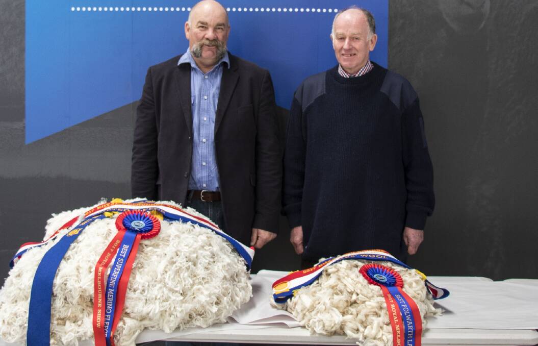 Craig Trickey, Coryule Merinos, Willowvale, and Doug Hopkins, Challicum Polwarth stud, Buangor, with their respective champion skirted fleece and champion lambs' wool of the Royal Melbourne Show Fleece Competition.
