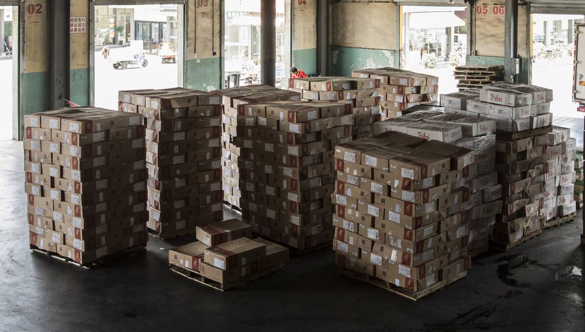 Boxes of imported meat sit stacked ready for dispatch at a distribution centre in Shanghai, China.